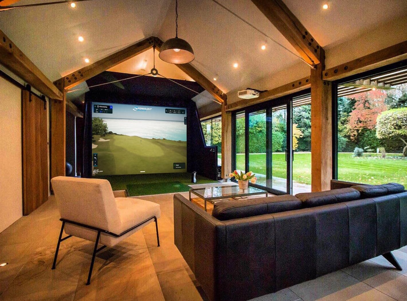 Foresight golf simulator in a timber-framed room with glass walls