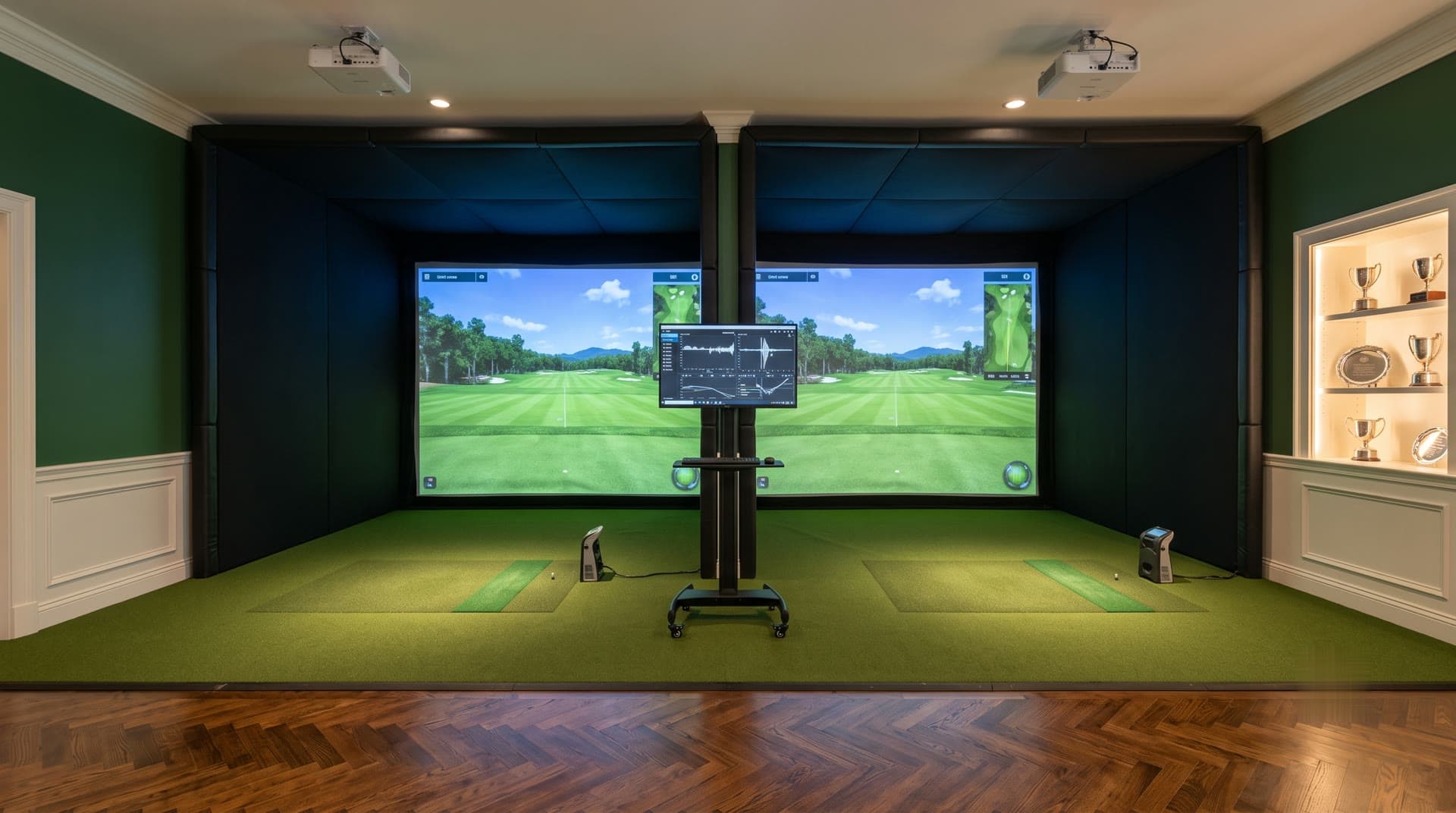Country club teaching studio with two padded simulator bays, dual projectors, and coaching monitor
